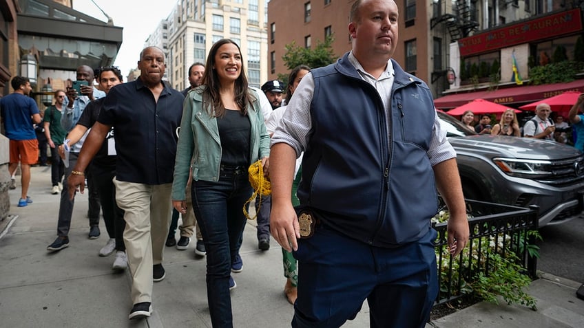 aoc joins thousands in new york climate change march with furious message for biden