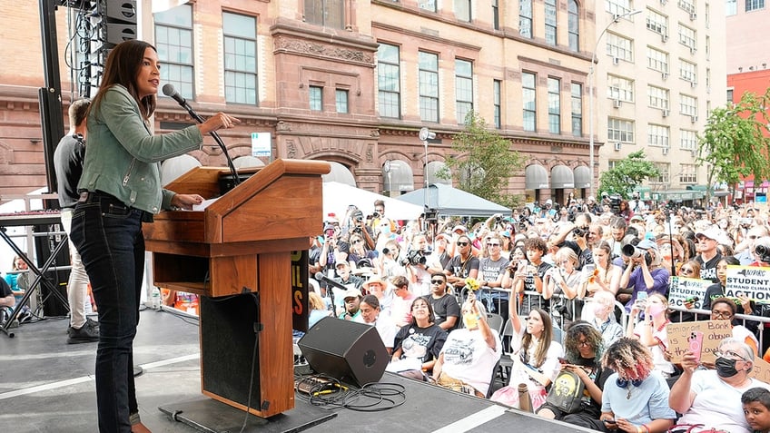 aoc joins thousands in new york climate change march with furious message for biden