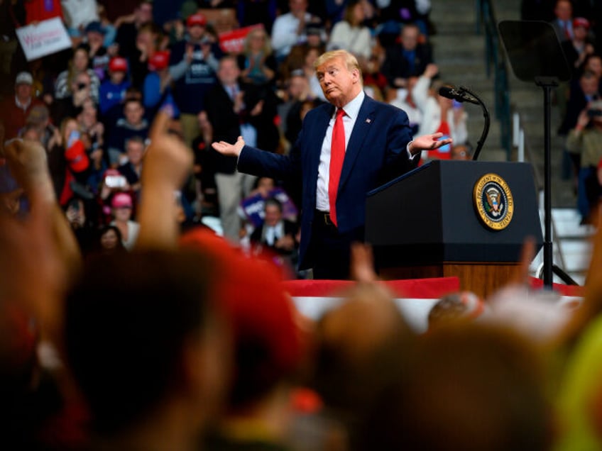 US President Donald Trump looks at his supporters after reading words from Al Wilson's son