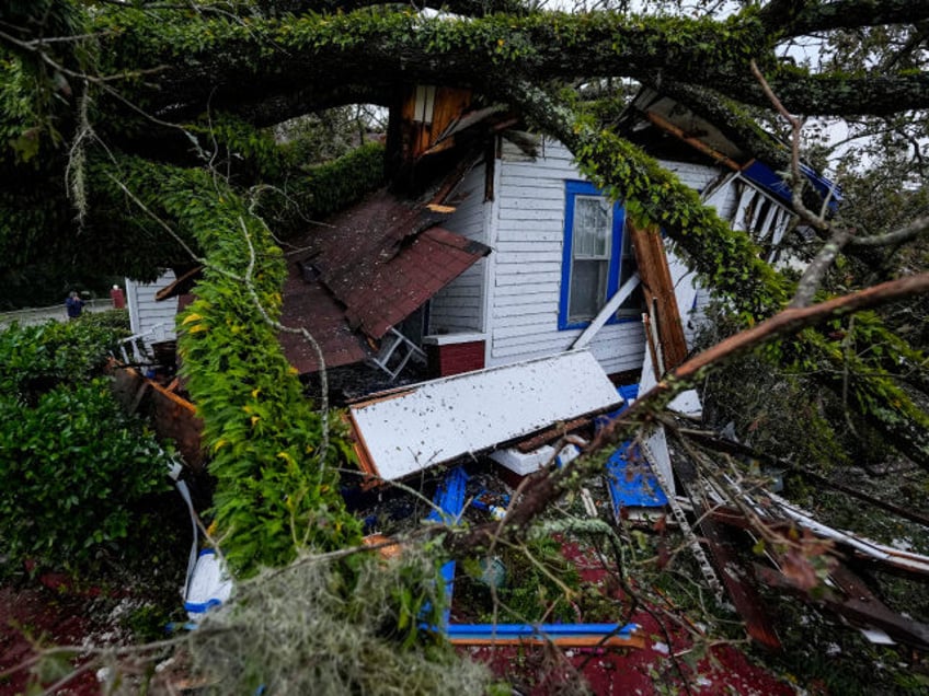 A damaged 100-year-old home is seen after an Oak tree landed on it after Hurricane Helene