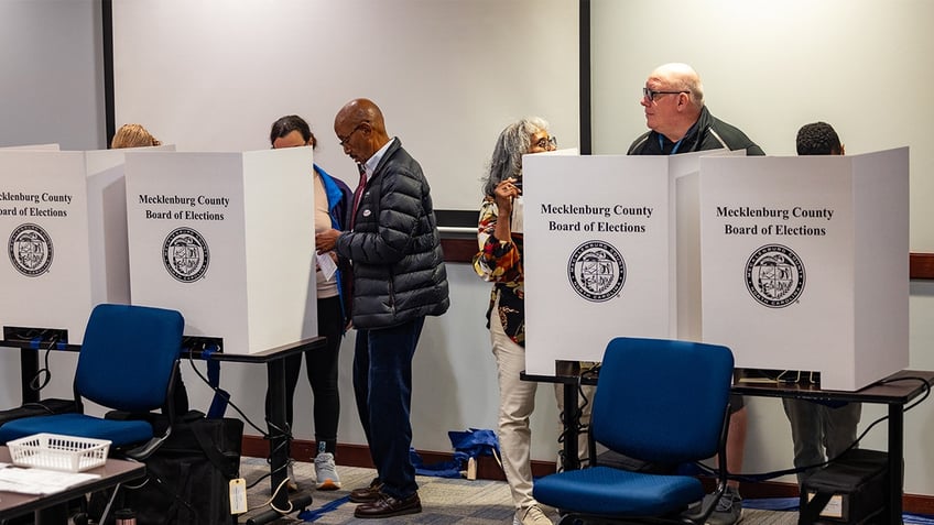 Voters cast their ballots at an early voting location ahead of the upcoming general election in Mecklenburg County, North Carolina, on Oct. 25, 2024 (Photo by Nathan Posner/Anadolu via Getty Images)