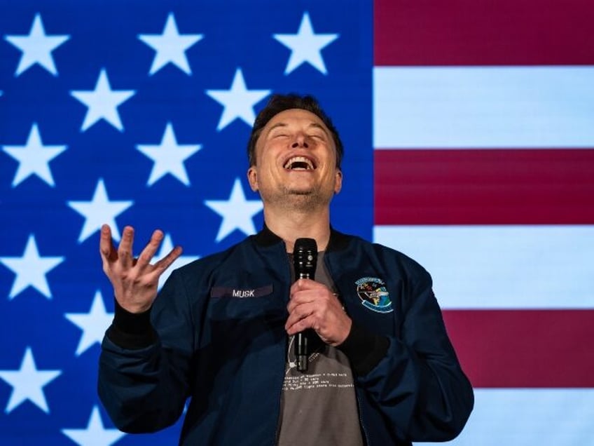 Elon Musk laughing on stage