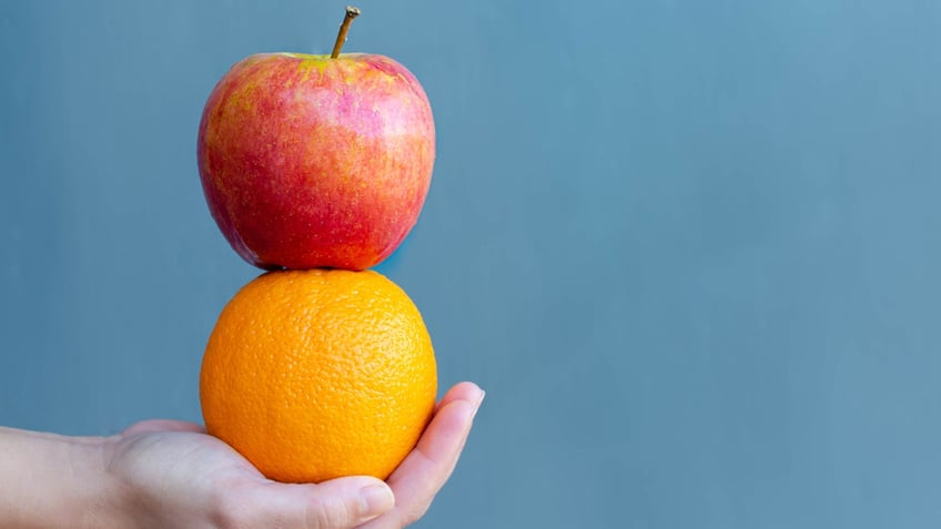 apple on top of an orange