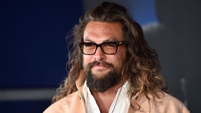 Jason Momoa glasses, pink jacket, and white shirt