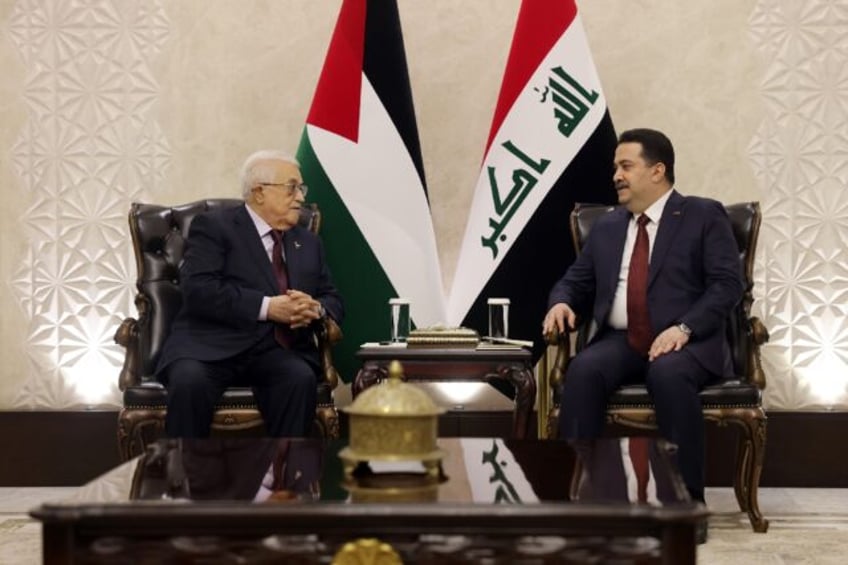 Iraqi Prime Minister Mohammed Shia al-Sudani (R) hold talks with Palestinian president Mah
