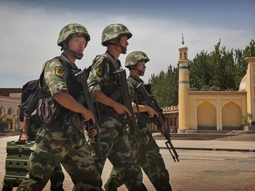 KASHGAR, CHINA - JULY 31: Chinese soldiers march in front of the Id Kah Mosque, China's la