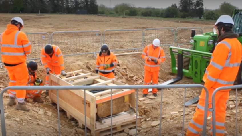 Highway workers near coffin