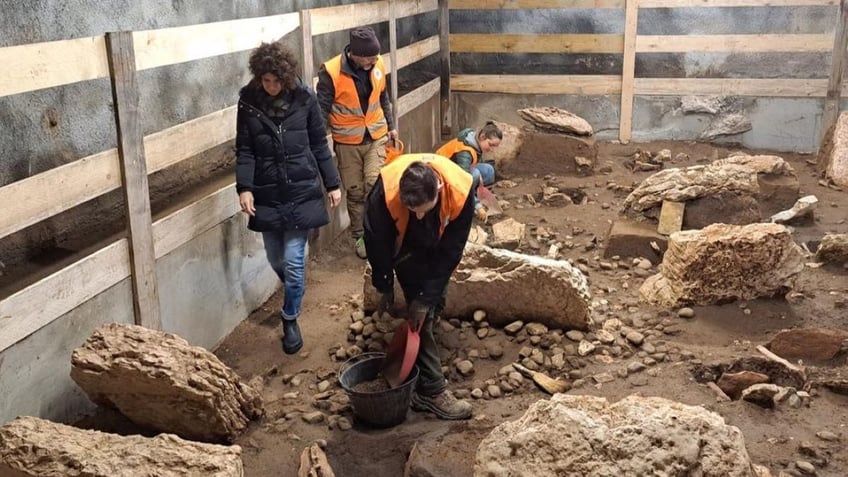 Archaeologists digging at site