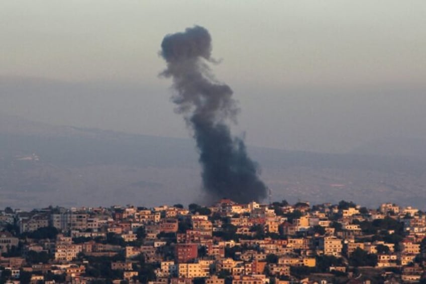 Smoke billows from the site of an Israeli airstrike targeting a southern Lebanese village