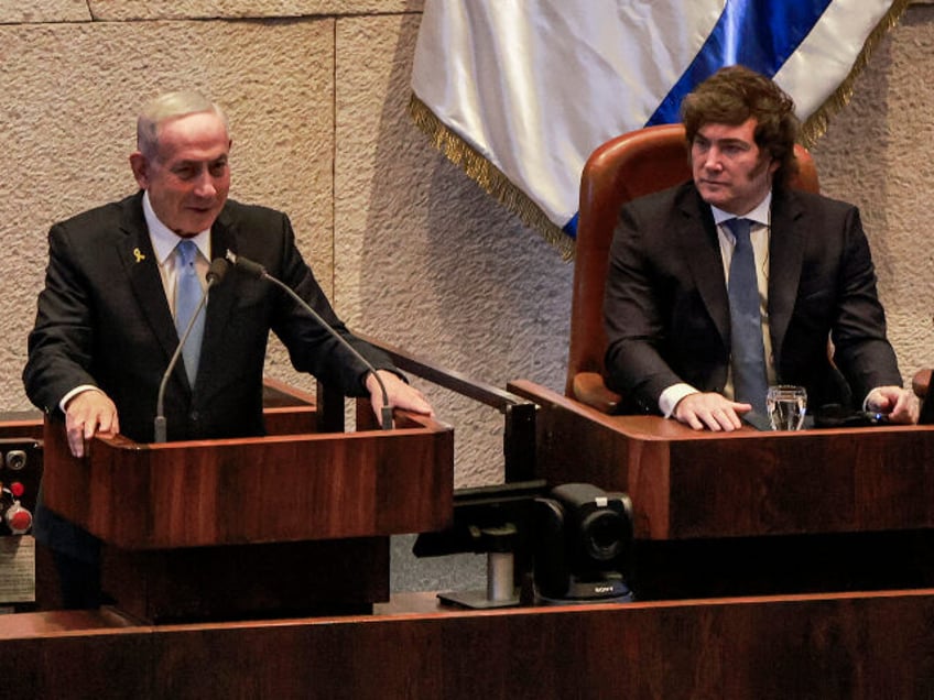 Argentina's President Javier Milei (R) watches as Israel's Prime Minister Benjam