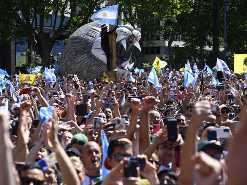 Supporters of Argentina's new president Javier Milei celebrate as he speaks at the crowd from a balcony of the Casa Rosada government palace during his inauguration day in Buenos Aires on December 10, 2023. Libertarian economist Javier Milei was sworn in Sunday as Argentina's president, after a resounding election victory …