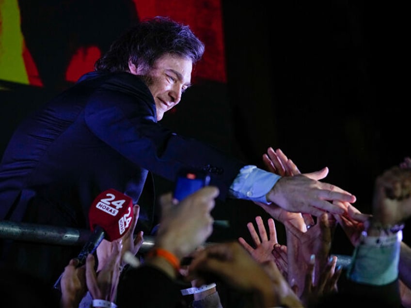 Presidential candidate of the Liberty Advances coalition Javier Milei greets supporters outside his campaign headquarters after winning the presidential runoff election in Buenos Aires, Argentina, Sunday, Nov. 19, 2023. (AP Photo/Natacha Pisarenko)