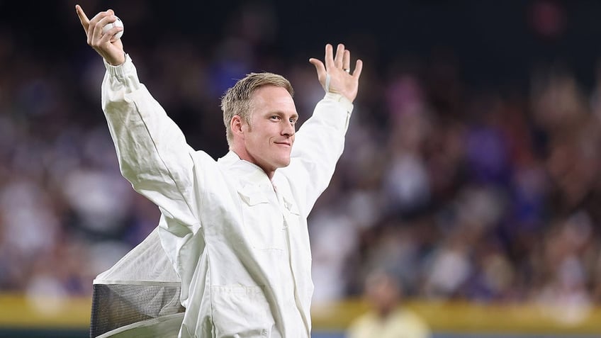 Beekeeper Matt Hilton throws out the first pitch