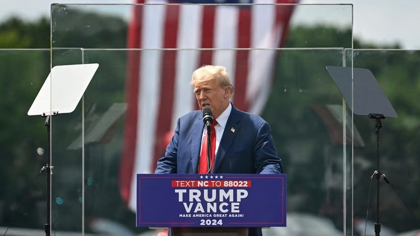 Trump appears in Asheboro, North Carolina behind bulletproof glass