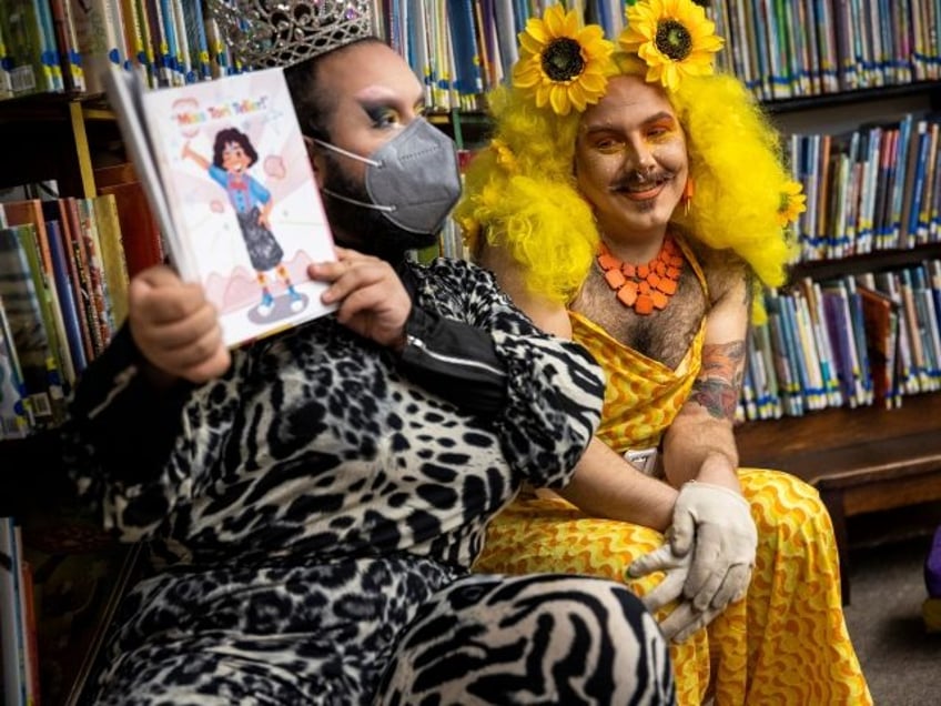 Chelsea, MA - June 25: Drag queens Just JP, left, and Sham Payne read stories to children