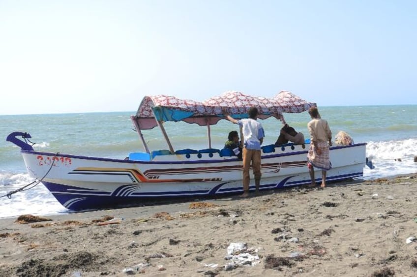 Yemenis ride a fishing boat on the coast of the Red Sea port of Hodeida