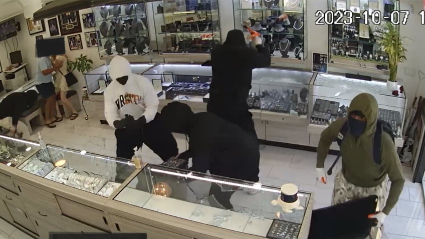 armed jewelry store worker sends hammer wielding burglars running for their lives