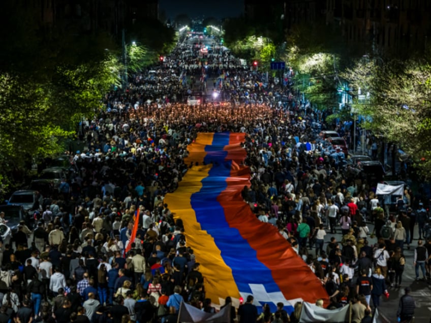 Armenians march during the annual torch march on the eve of the Genocide Remembrance Day beginning at Republic Square and ending at the Tsitsernakaberd Genocide Memorial on Wednesday, April 23, 2024. The Armenian Genocide Remembrance Day is a public holiday and observed on April 24th each year to commemorate the victims of the Armenian genocide between 1915 to 1923. On the night of April 23rd a torch march of tens of thousands of people walk to the Tsitsernakaberd Genocide Memorial in Yerevan to lay flowers at the eternal flame, this is continued all day on April 24th. Memorial Day is observed in Armenia, the state of California, Canada, France, and Argentina. It is estimated that between 600,000 to 1.5 million Armenians died as a result. (Photo by Anthony Pizzoferrato / Middle East Images / Middle East Images via AFP) (Photo by ANTHONY PIZZOFERRATO/Middle East Images/AFP via Getty Images)