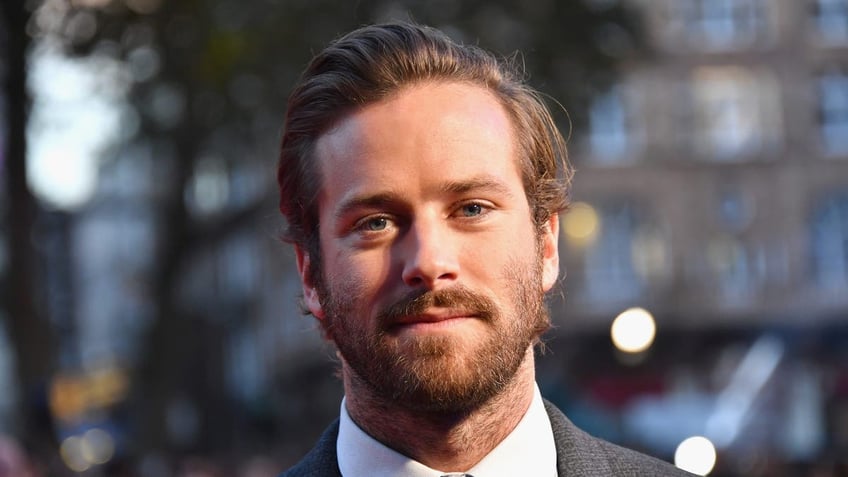 Armie Hammer wears a suit on the red carpet in London.