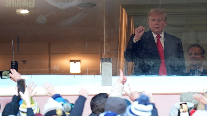 Trump saluting fans