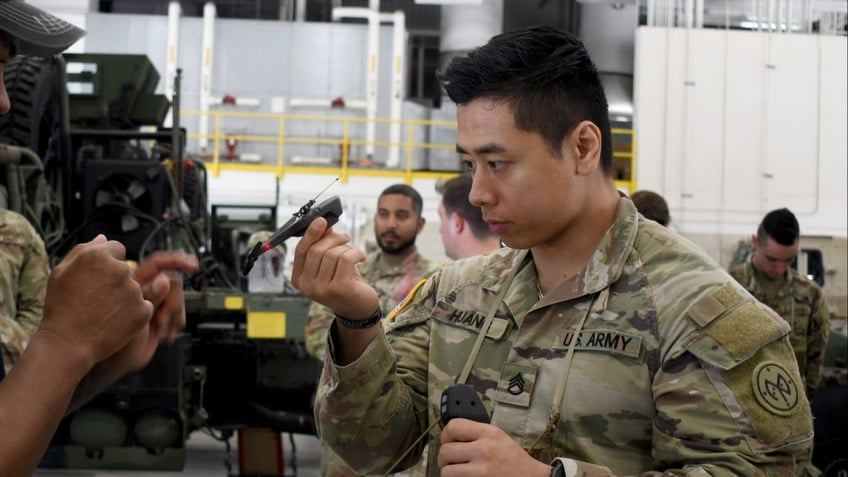 Army soldier holds small drone