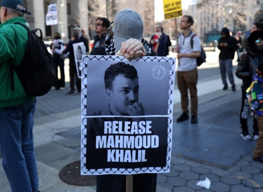 A protester in New York holds a sign calling for the release of pro-Palestinian activist M