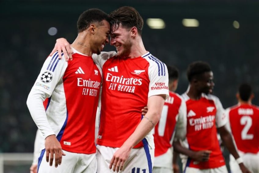 Arsenal's Gabriel Magalhaes (L) and Declan Rice celebrate their win over Sporting Lisbon