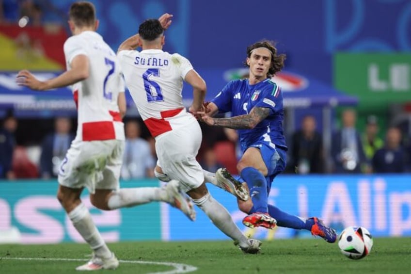 On his way to Arsenal: Italy defender Riccardo Calafiori (R)