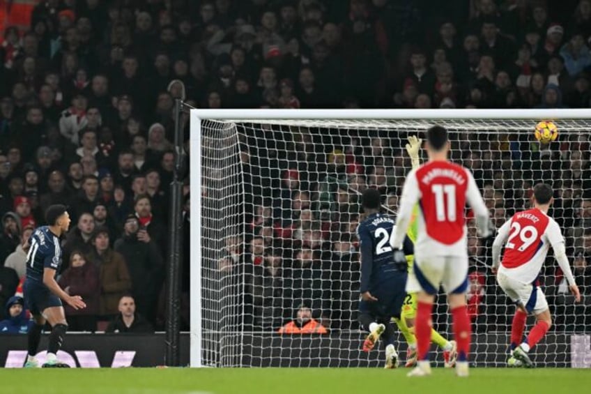 Aston Villa's Ollie Watkins (L) watches his equaliser against Arsenal