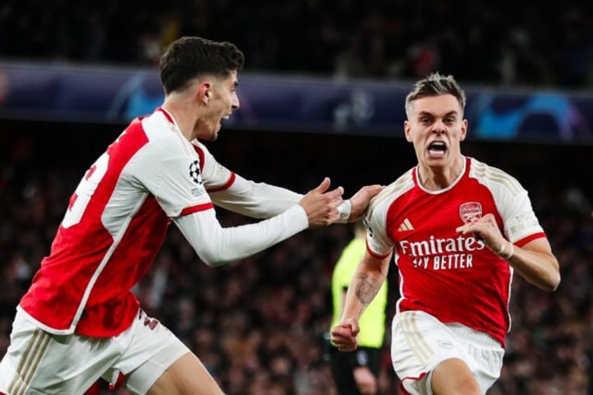 Arsenal's Leandro Trossard (R) celebrates after scoring against Bayern Munich