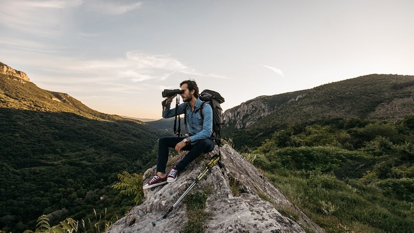 Hiker looking in binoculars