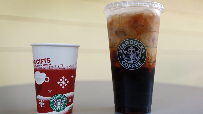 A Tall cup next to a Trenta cup. 