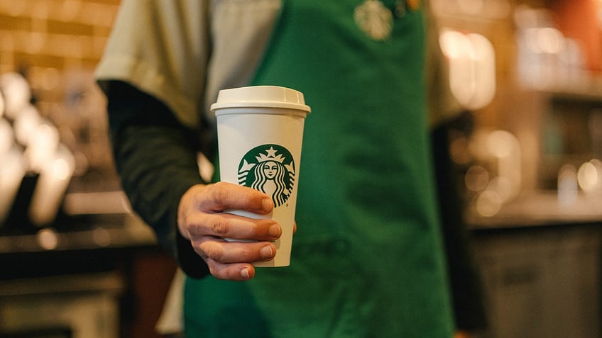 Man holding coffee cup.