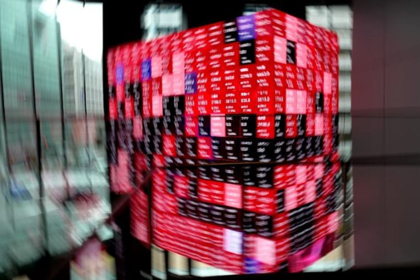An electronic board shows the Nikkei 225 index on the Tokyo Stock Exchange at an office bu