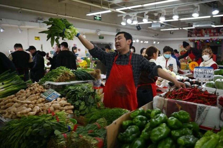 Locals at a busy Beijing market largely shrugged off an escalating trade war after Chinese