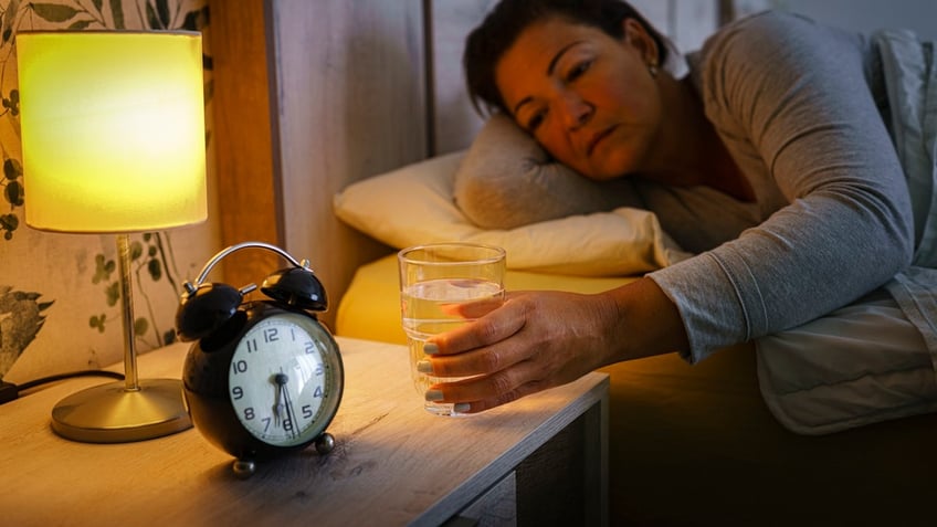 Woman drinking in bed