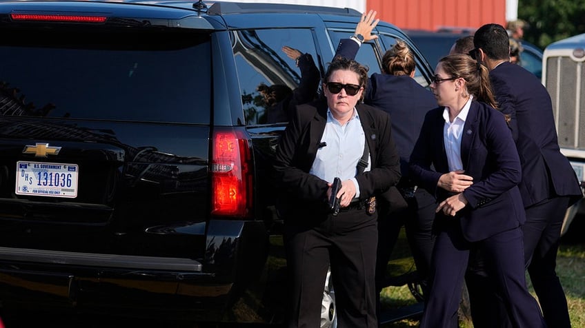 The vehicle carrying Republican presidential candidate former President Donald Trump is surrounded by U.S. Secret Service