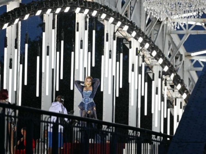 A model displays creations while walking a catwalk erected along the Passerelle Debilly br