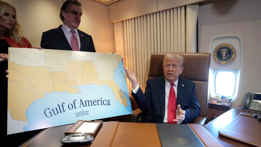 President Donald Trump, from right, speaks to reporters accompanied by Interior Secretary Doug Burgum and Burgum's wife Kathryn Burgum, aboard Air Force One where Trump signed a proclamation declaring Feb. 9 Gulf of America Day, as he travels from West Palm Beach, Fla. to New Orleans, Sunday, Feb. 9, 2025. (AP Photo/Ben Curtis)