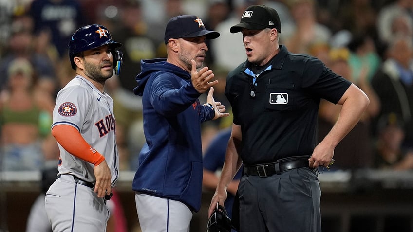 Joe Espada and Jose Altuve argue with umpire