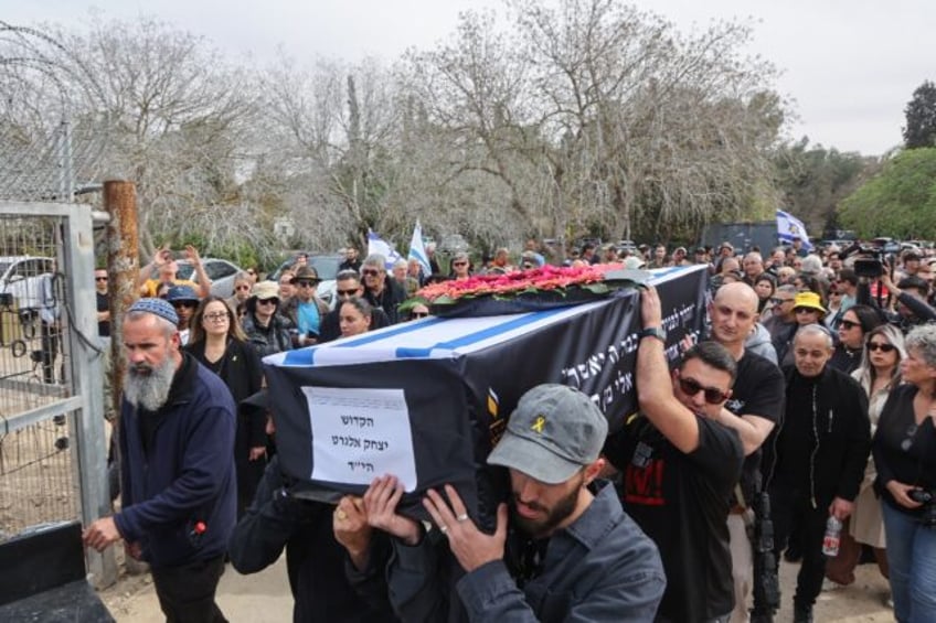 Hundreds of mourners came to pay their respects as Elgarat's black coffin topped with an I