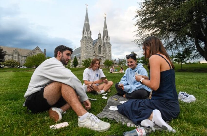 Students play cards outside of St. Thomas of Villanova Church at the campus of Villanova U