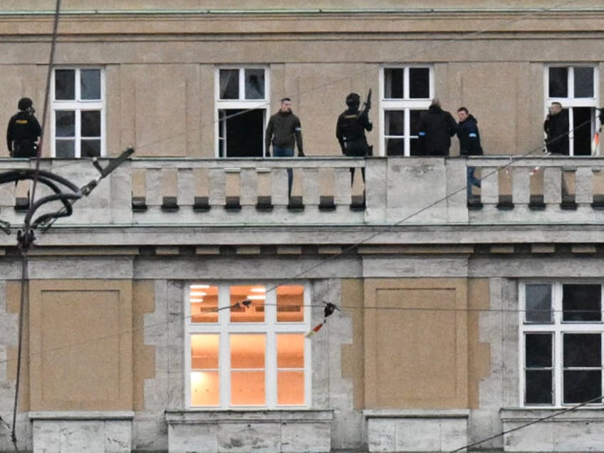 TOPSHOT - Armed police are seen on the balcony of the Charles University in central Prague, on December 21, 2023. Czech police said a shooting in a university building in central Prague has left "dead and wounded people", without providing further details. "Based on the initial information we have, we …