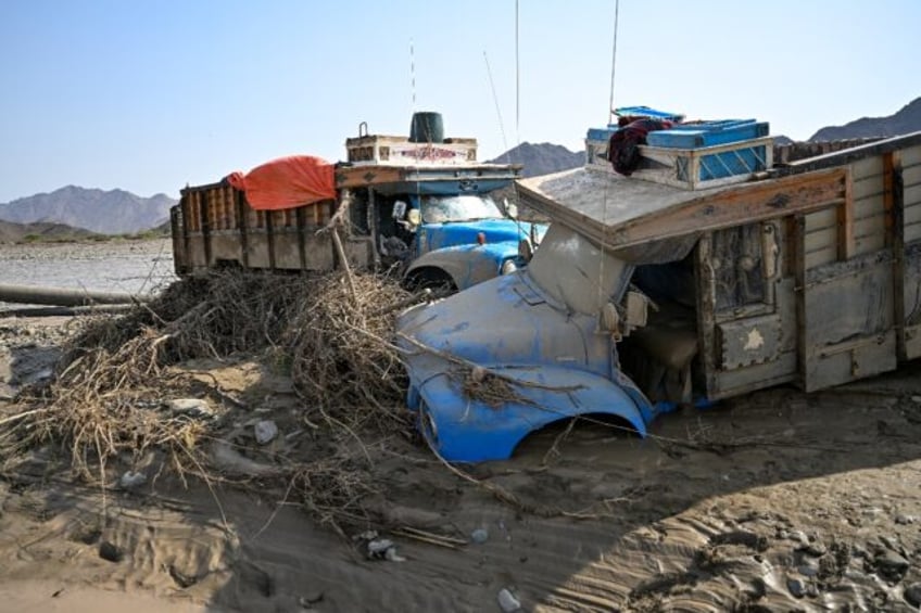 Damaged trucks burried in the mud after the collapse of the Arbaat Dam in northeast Sudan