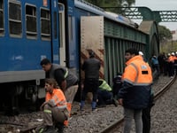At least 90 injured after passenger train hits boxcar, derails in Argentine capital