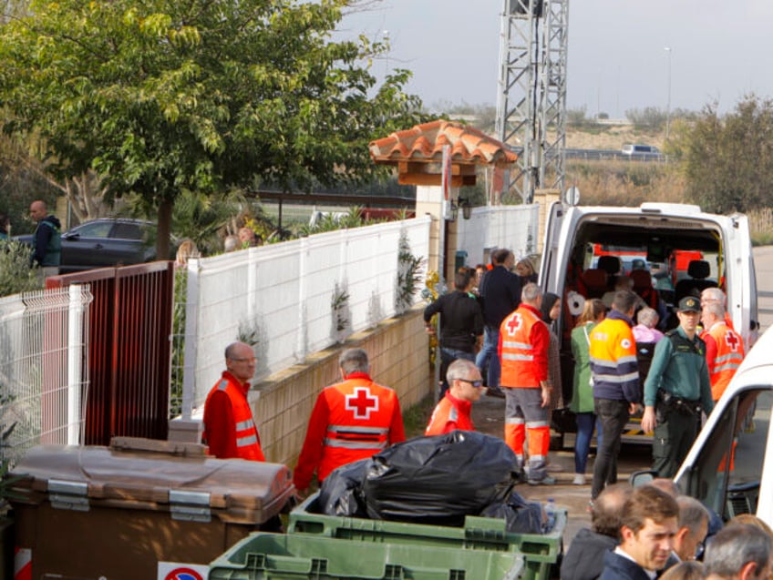 Emergency crews and police work on the nursing home where least 10 people have died in a f