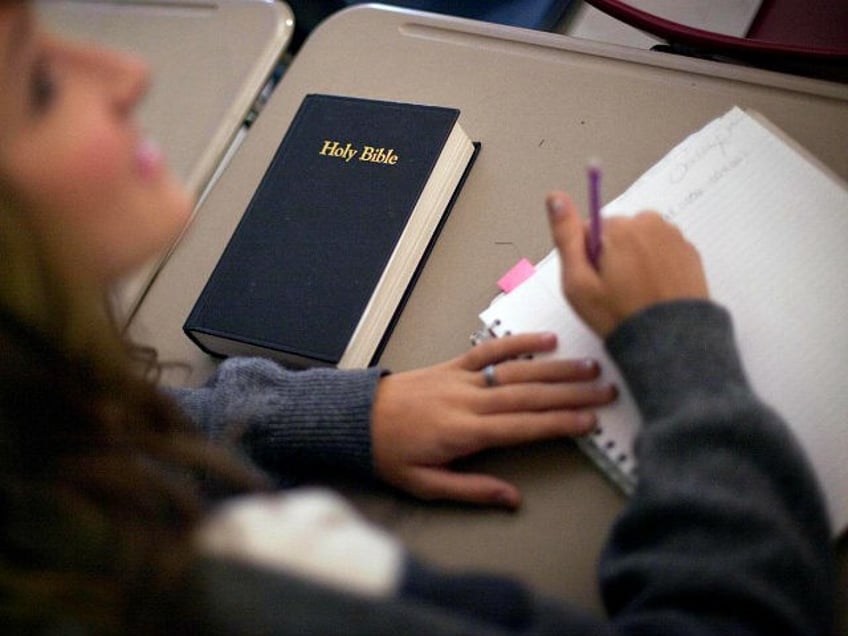 In this Thursday, Oct. 20, 2011, photo, a bible sits on the desk of Bradley Sabin, a junio