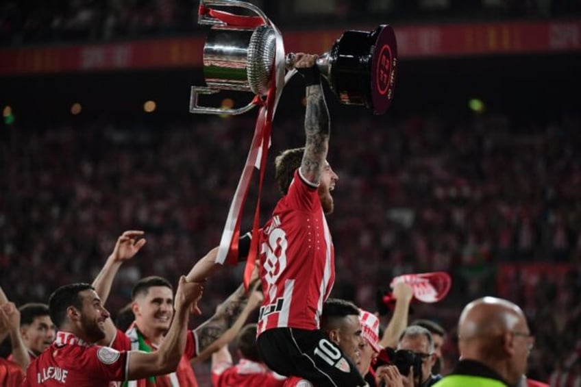 Athletic Bilbao captain Iker Muniain raises the trophy after winning the Copa del Rey agai