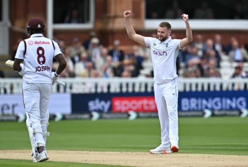 England's Gus Atkinson (R) celebrates after the dismissal of West Indies' Alzarri Joseph