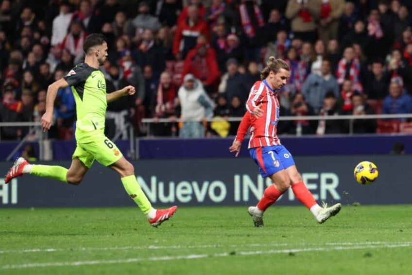 Atletico Madrid's French forward Antoine Griezmann finished with a fine chip to seal his t